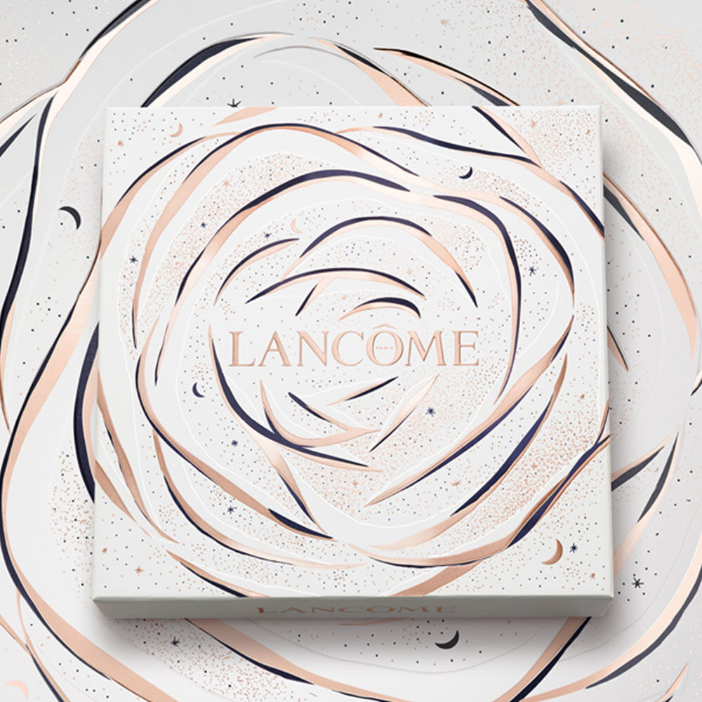A decorative box featuring the word "LANCOME" in elegant lettering, surrounded by a swirling rose design in soft colors against a textured background.