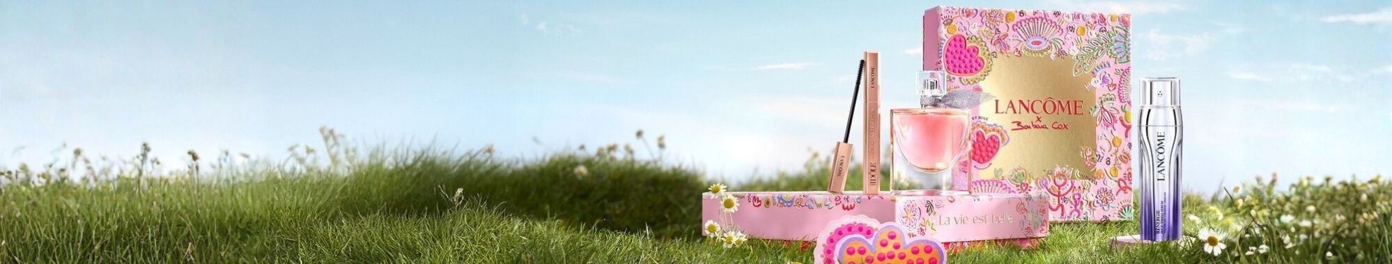 A visually striking display of neatly stacked beauty products, arranged in a pyramid shape, against a dark background adorned with whimsical stars and celestial doodles.